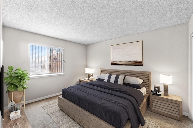 bedroom with a textured ceiling and baseboards