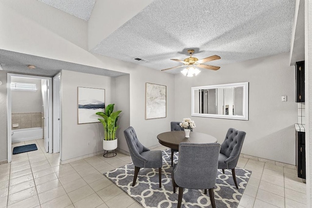 dining space with visible vents, ceiling fan, a textured ceiling, and light tile patterned floors