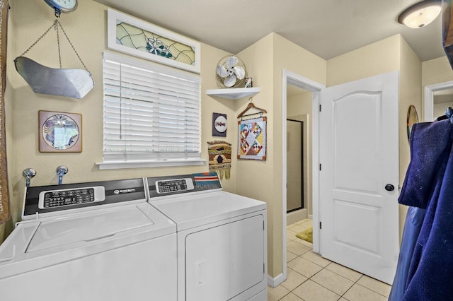 washroom featuring light tile patterned floors, laundry area, and separate washer and dryer