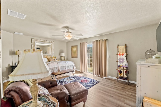 bedroom with light wood-type flooring, access to exterior, baseboards, and visible vents