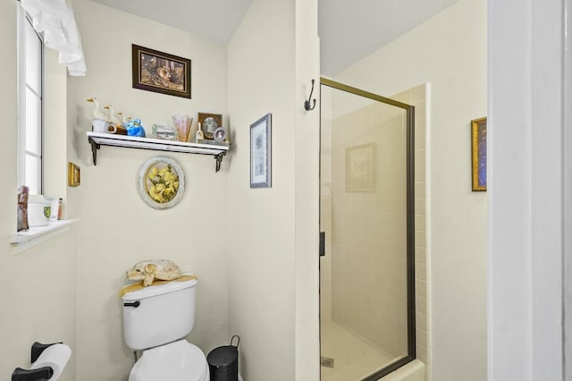 bathroom with toilet and a shower stall