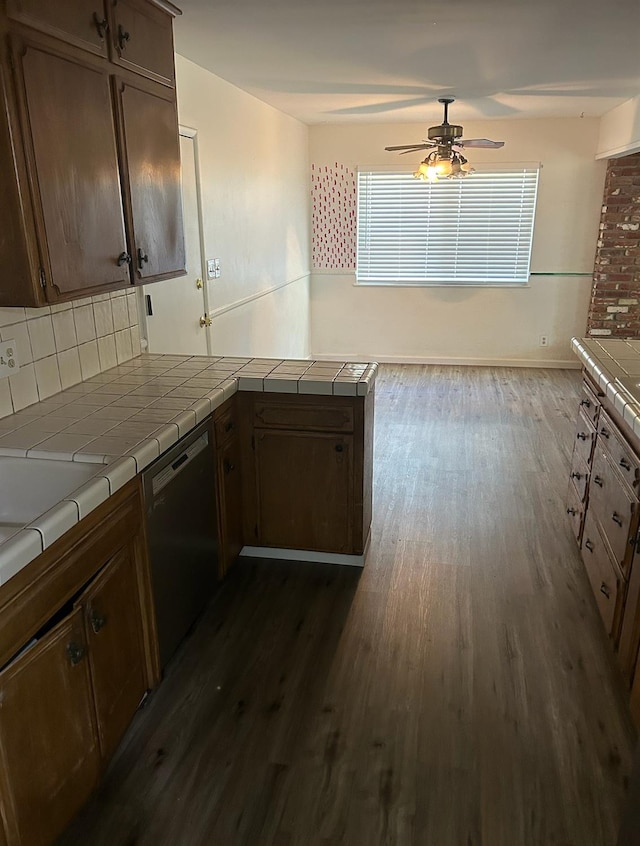 kitchen with tile counters, decorative backsplash, a ceiling fan, dishwasher, and dark wood-style floors