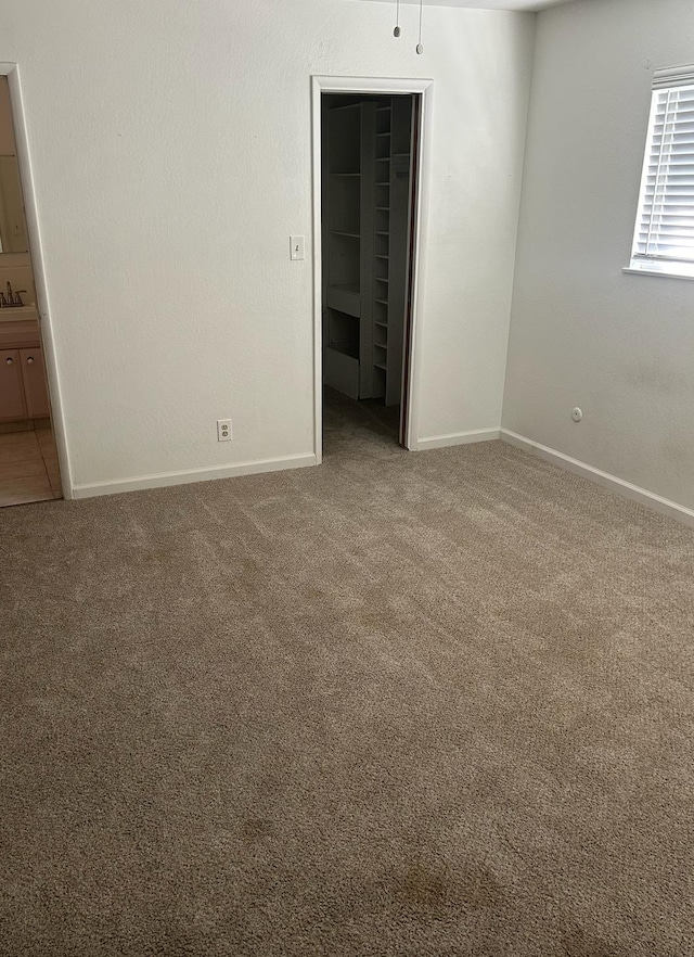 empty room with carpet and baseboards