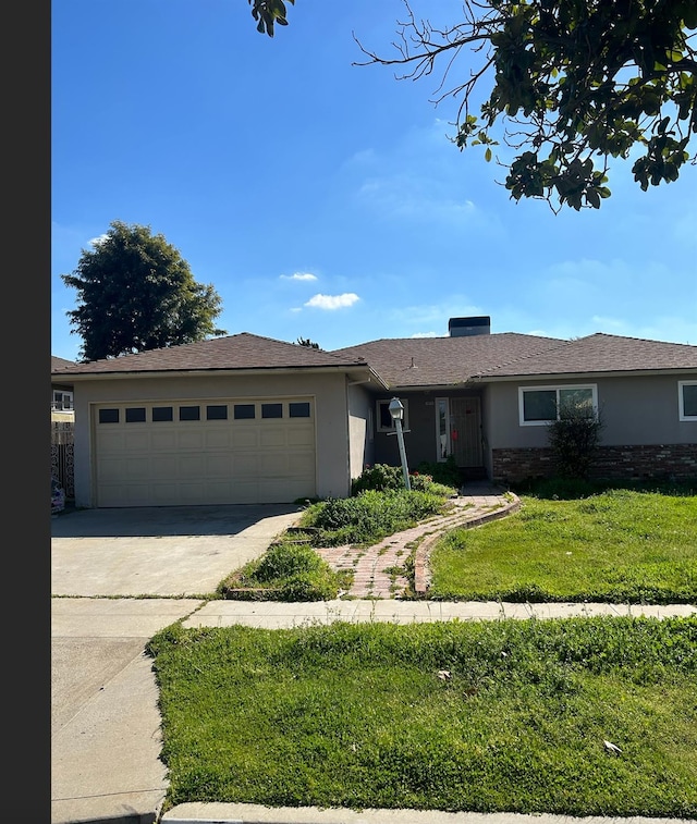 ranch-style home featuring a front yard, driveway, an attached garage, and stucco siding