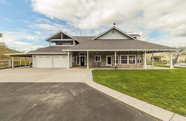 farmhouse-style home featuring an attached garage, driveway, roof with shingles, and a front yard