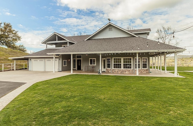 country-style home with an attached garage, driveway, a shingled roof, and a front yard