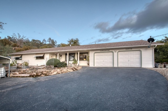 ranch-style house featuring an attached garage and driveway