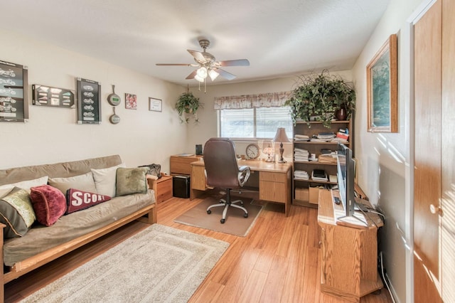 office with light wood-type flooring and a ceiling fan