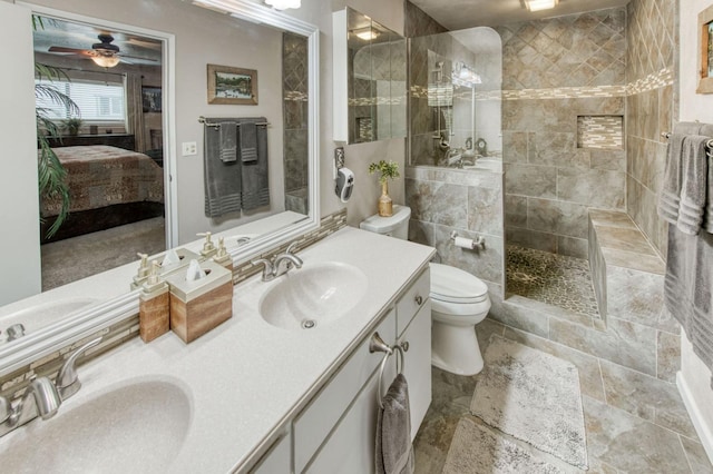 ensuite bathroom with a sink, toilet, double vanity, and ensuite bathroom