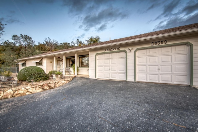 ranch-style house featuring aphalt driveway