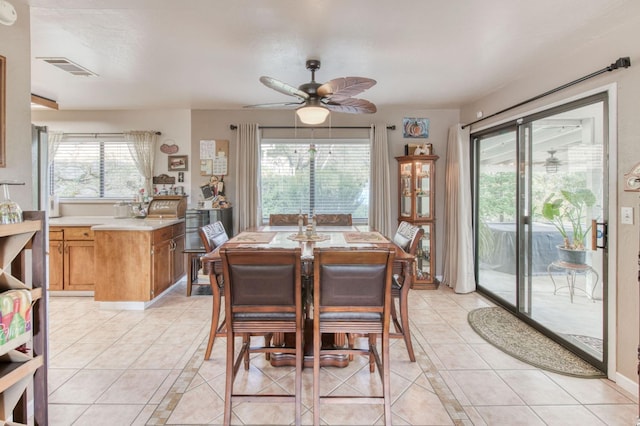 dining space with light tile patterned floors, visible vents, and a ceiling fan