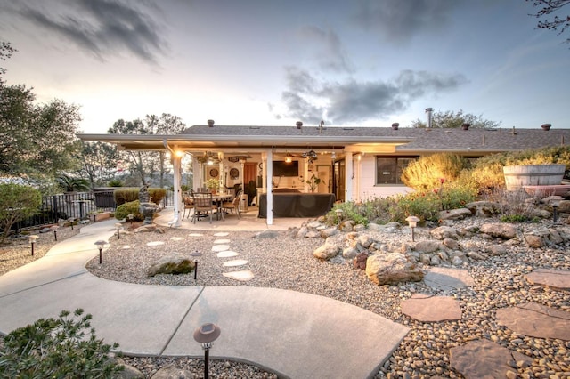 back of property featuring a patio and fence