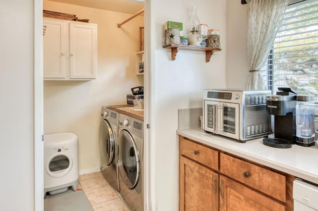 laundry area featuring a toaster, light tile patterned flooring, laundry area, and washing machine and clothes dryer