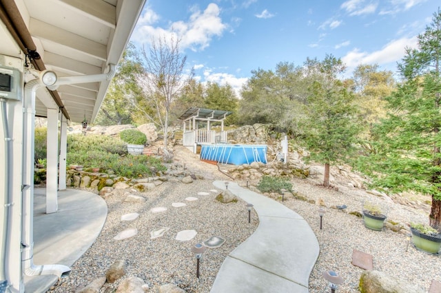 view of yard with an outdoor pool and a patio