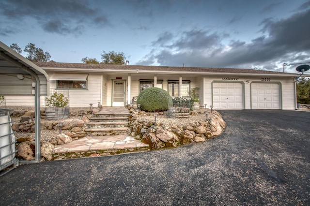 ranch-style home with driveway and a garage