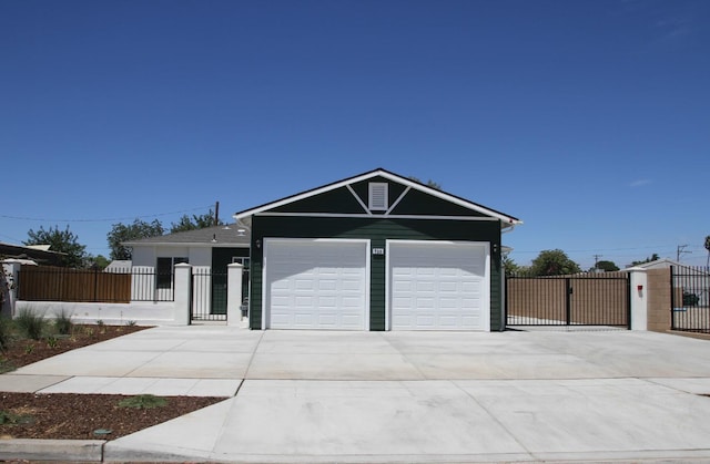 single story home featuring driveway, a fenced front yard, and a gate