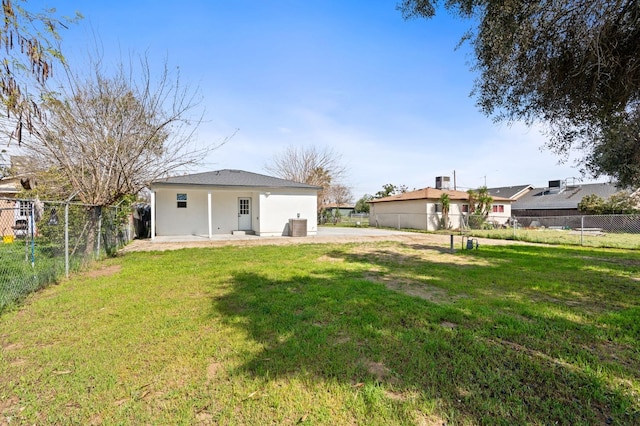 rear view of house with a patio area, a fenced backyard, and a yard