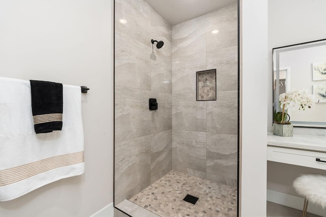 bathroom with a shower stall and vanity