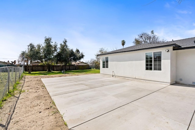 exterior space featuring a patio, a fenced backyard, and stucco siding