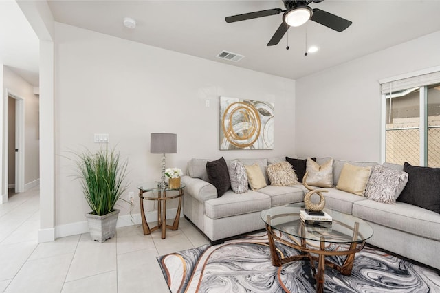 living room featuring visible vents, ceiling fan, baseboards, and light tile patterned floors