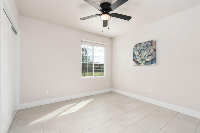 unfurnished bedroom with a closet, ceiling fan, baseboards, and light tile patterned floors