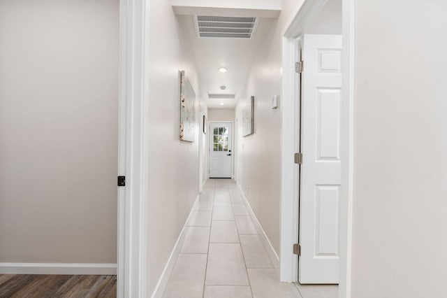 hall featuring recessed lighting, visible vents, baseboards, and light tile patterned flooring