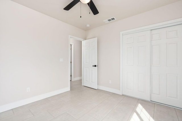 unfurnished bedroom with a ceiling fan, a closet, visible vents, and baseboards