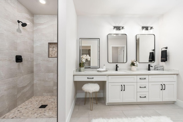 full bathroom with double vanity, a sink, walk in shower, baseboards, and tile patterned floors