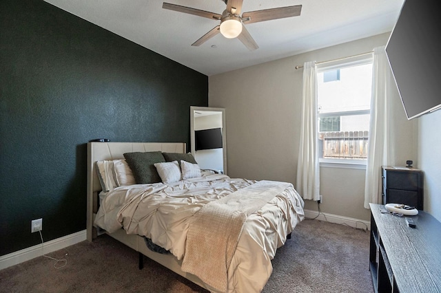 carpeted bedroom with baseboards and a ceiling fan