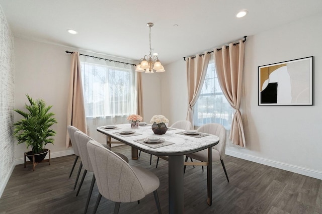 dining space with dark wood-style floors, recessed lighting, a notable chandelier, and baseboards