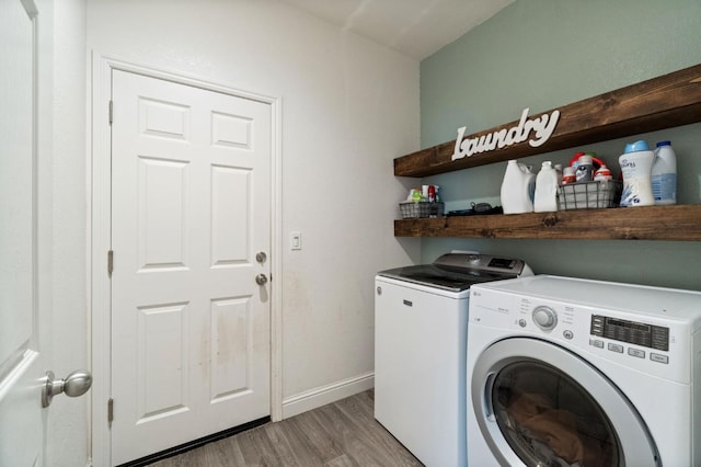 laundry room with light wood-style floors, laundry area, independent washer and dryer, and baseboards