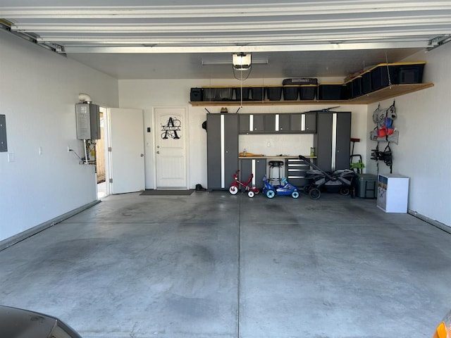 garage featuring water heater and a garage door opener