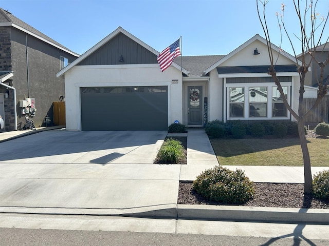 view of front of property featuring a garage, driveway, and stucco siding