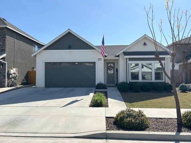 ranch-style home featuring a garage, driveway, fence, and stucco siding