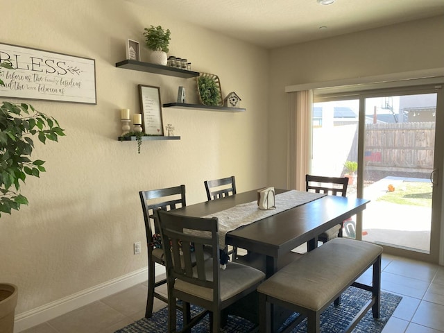 dining area with tile patterned flooring and baseboards