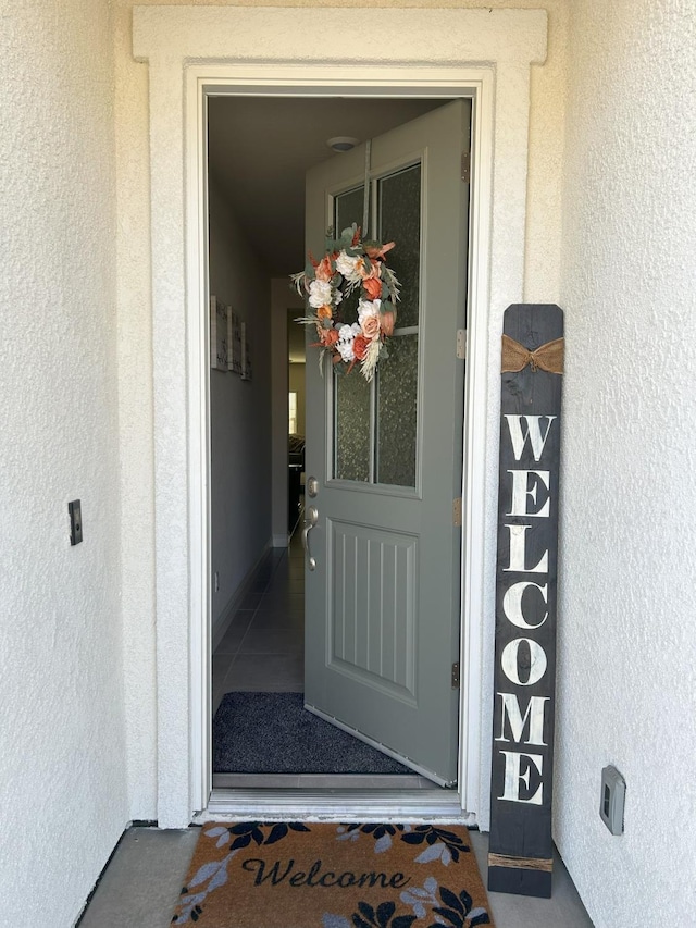 entrance to property with stucco siding