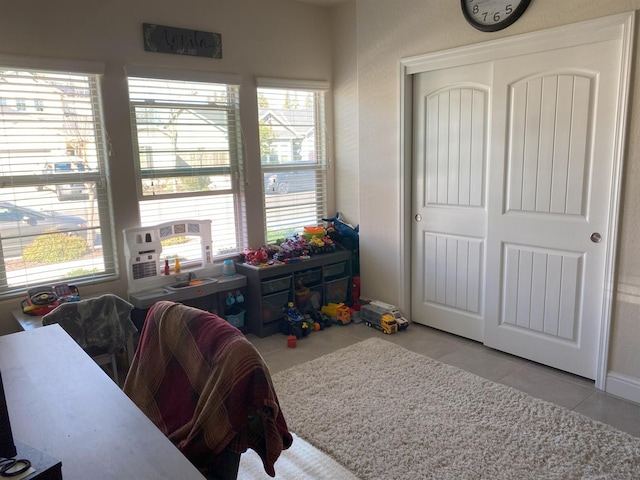 game room featuring light tile patterned floors and plenty of natural light