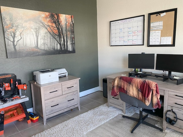 office space featuring dark tile patterned flooring and baseboards