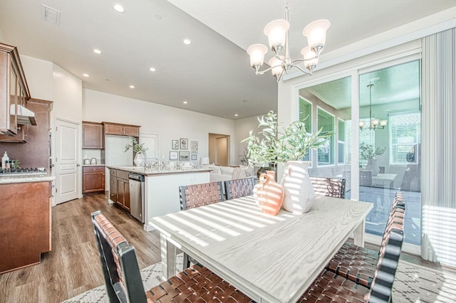 dining space with light wood-style floors, visible vents, a notable chandelier, and recessed lighting