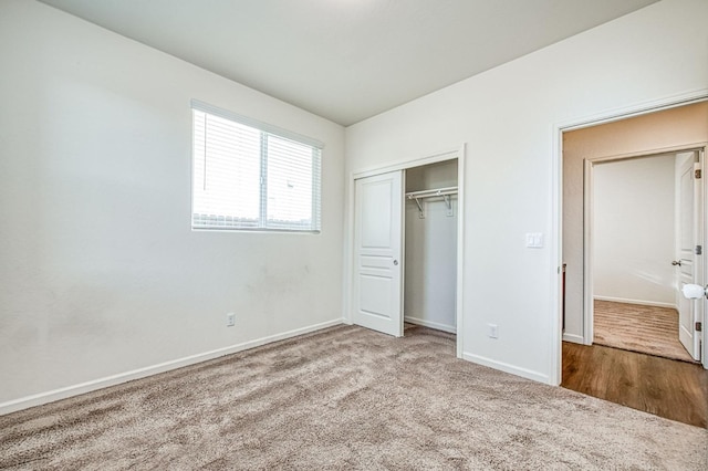 unfurnished bedroom featuring a closet, carpet flooring, and baseboards