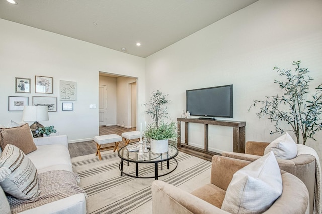 living room featuring recessed lighting, wood finished floors, and baseboards