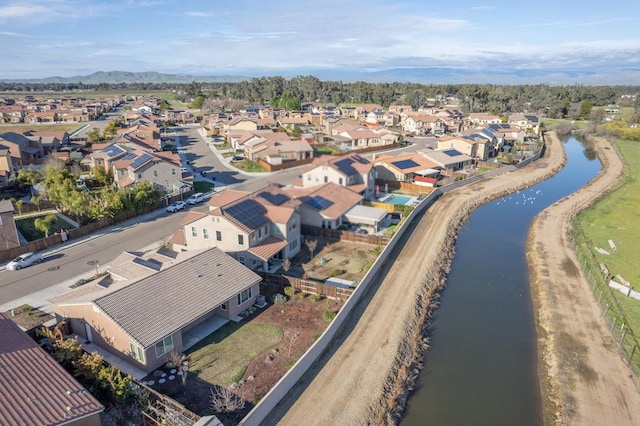 birds eye view of property with a water view and a residential view