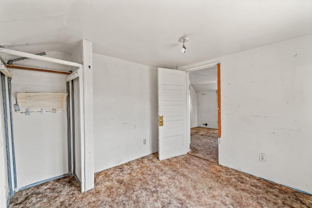 unfurnished bedroom with a closet and carpet flooring