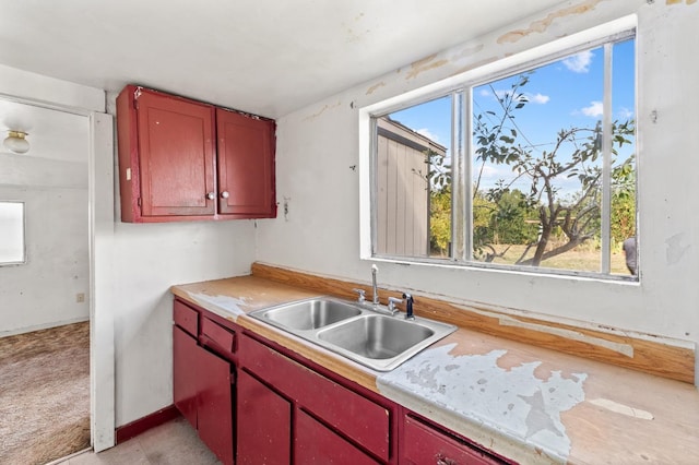 kitchen featuring light countertops and a sink