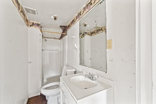 full bath with toilet, visible vents, walk in shower, and vanity