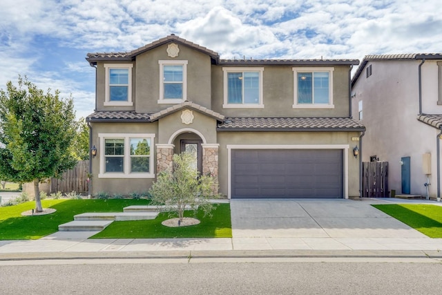 mediterranean / spanish-style home with concrete driveway, a tiled roof, an attached garage, fence, and stucco siding