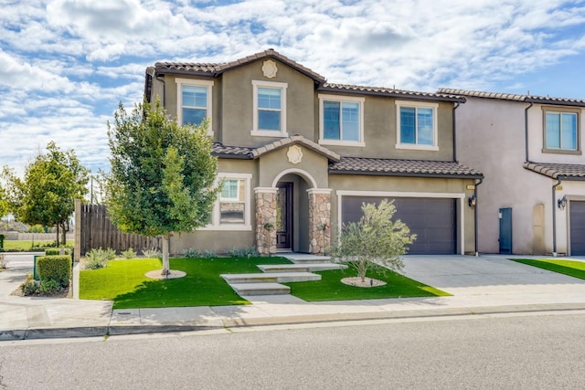 mediterranean / spanish house with stucco siding, an attached garage, fence, driveway, and a tiled roof