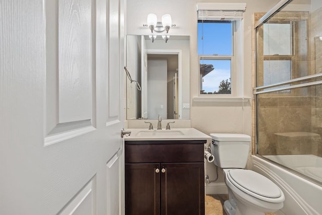 full bathroom featuring vanity, toilet, and bath / shower combo with glass door