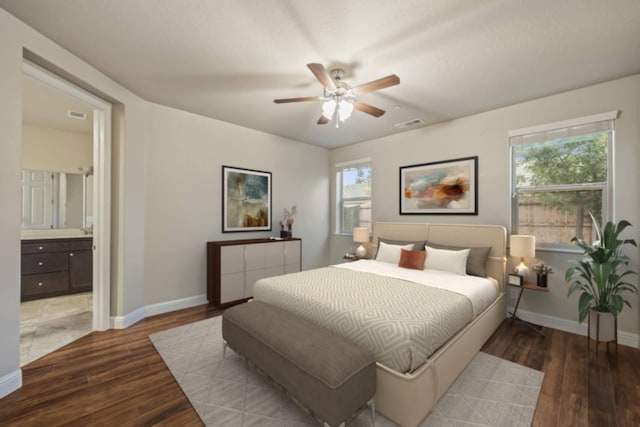 bedroom featuring multiple windows, wood finished floors, and baseboards