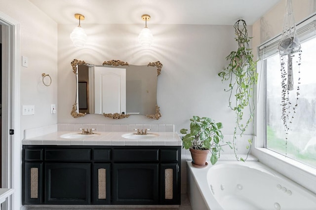 full bath featuring a sink, a tub with jets, and double vanity